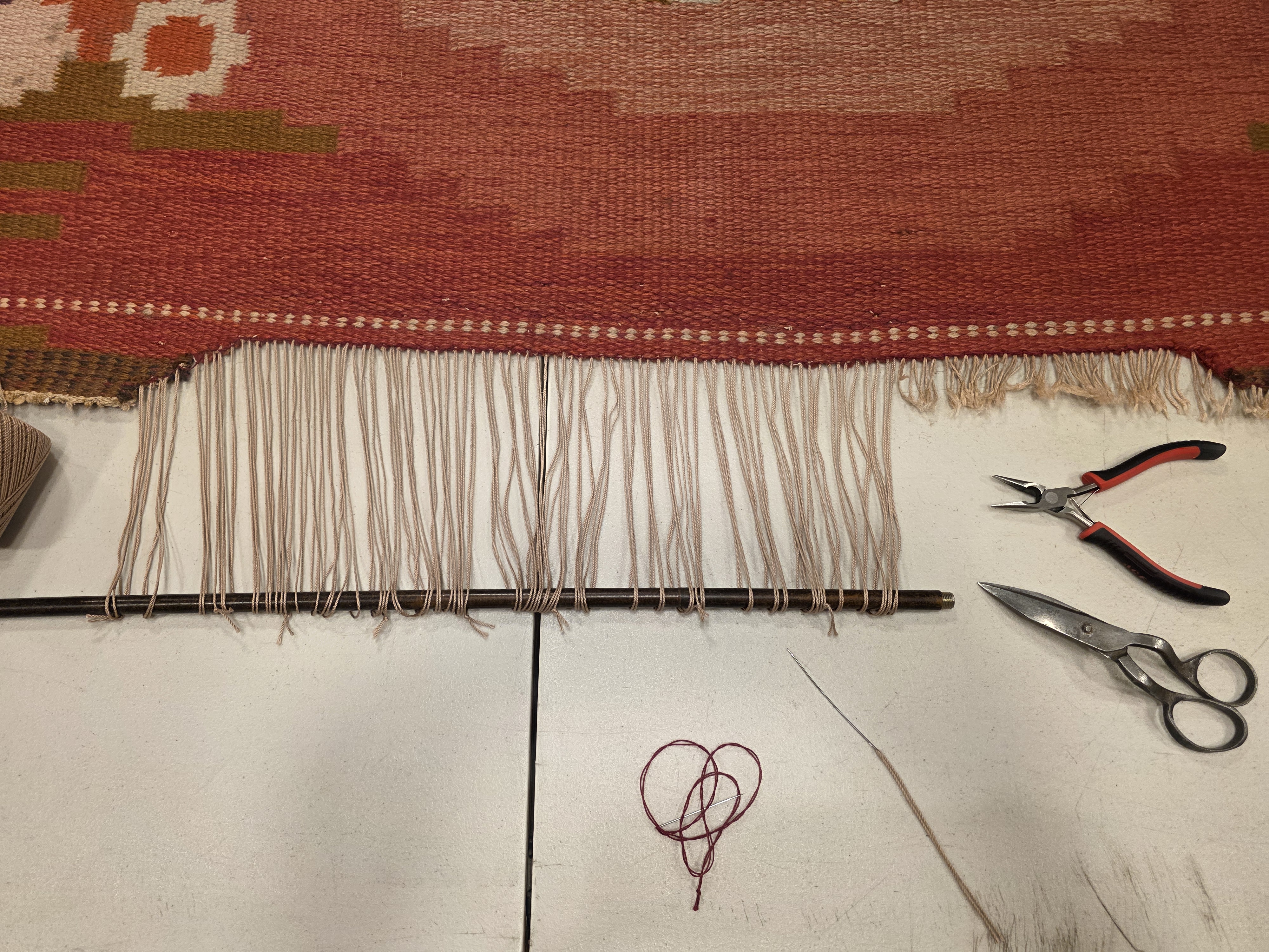 New foundation threads being installed along a damaged kilim edge