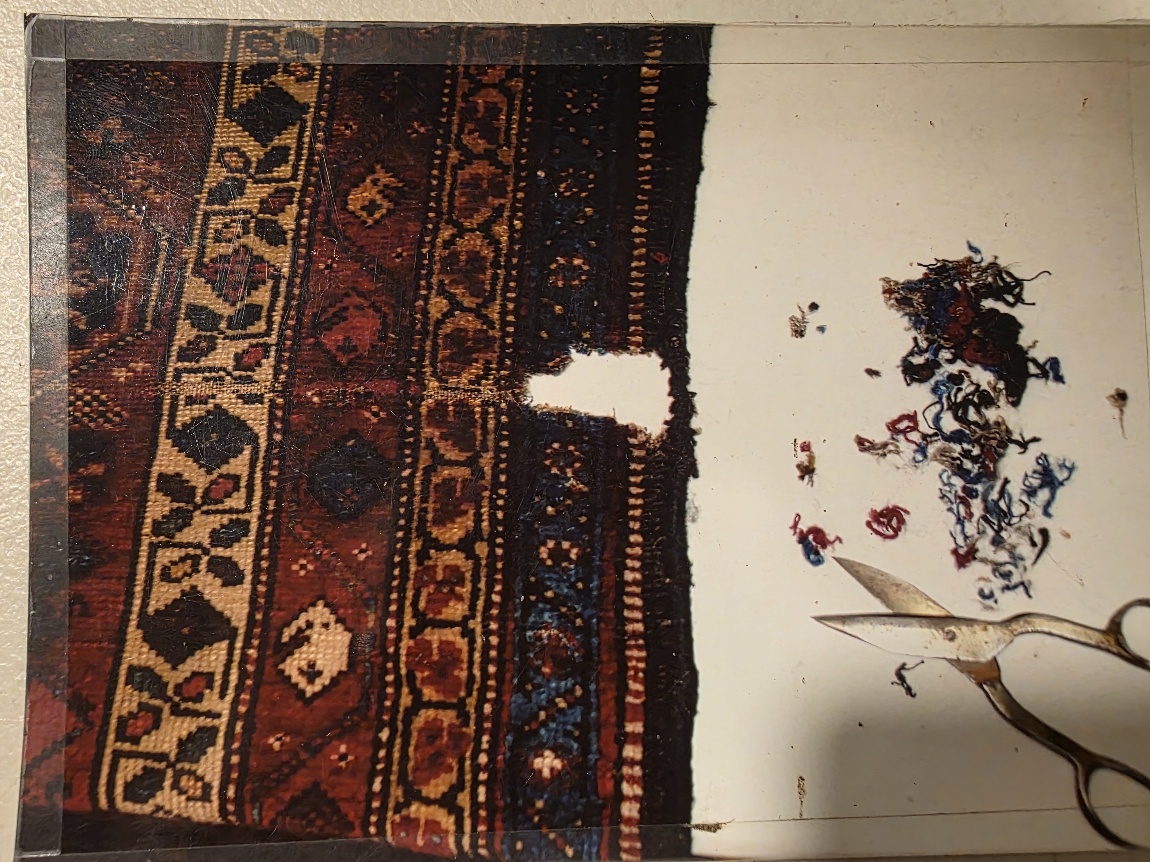 Oriental rug with a large section missing from the corner before repair