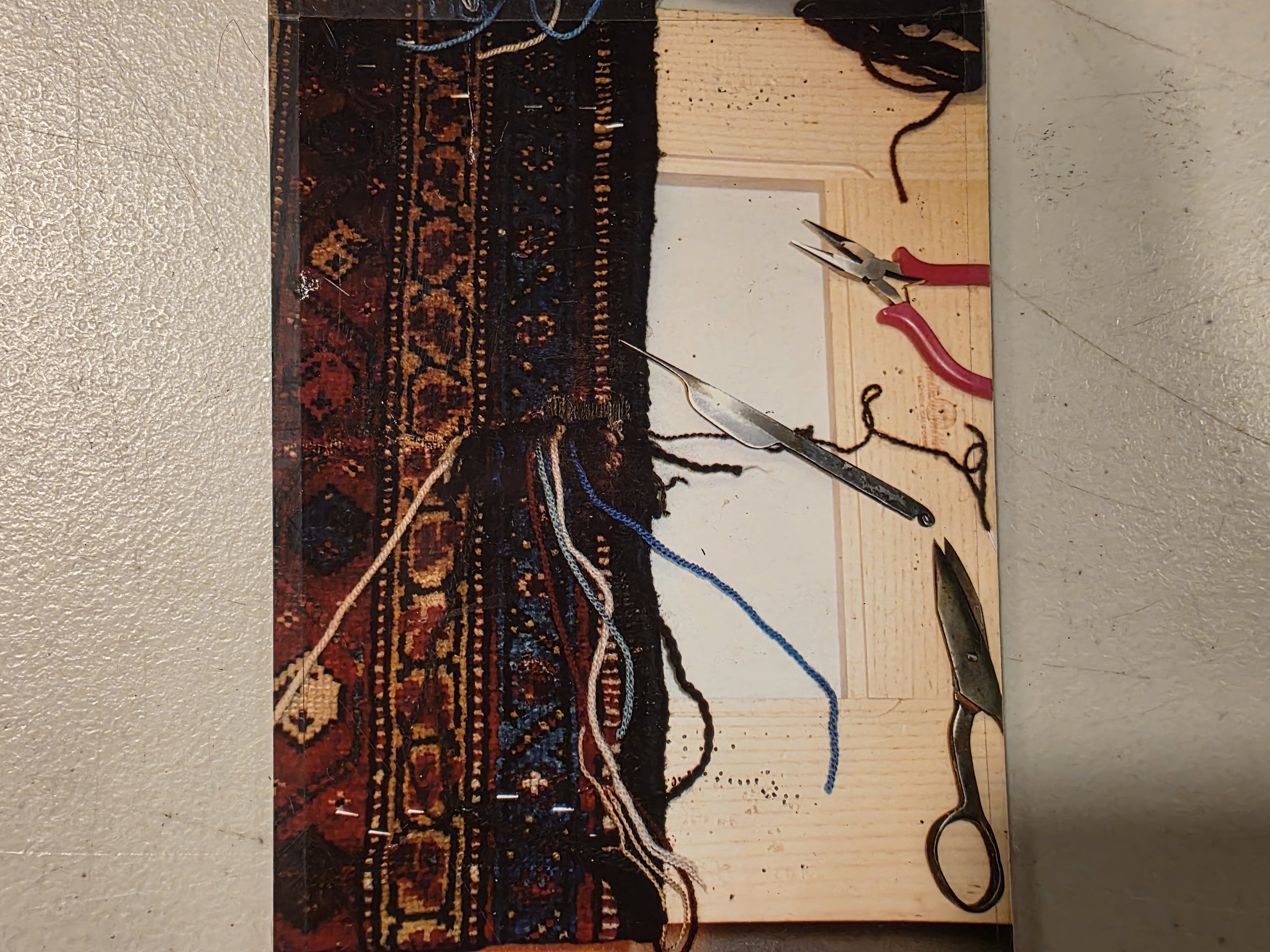 Oriental rug corner being reconstructed by hand with new yarn