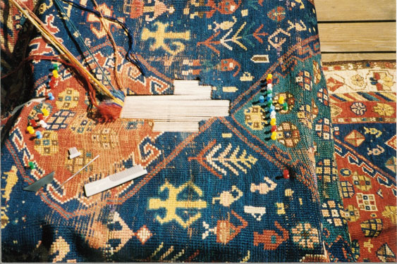 Hand reweaving in progress with warp threads visible